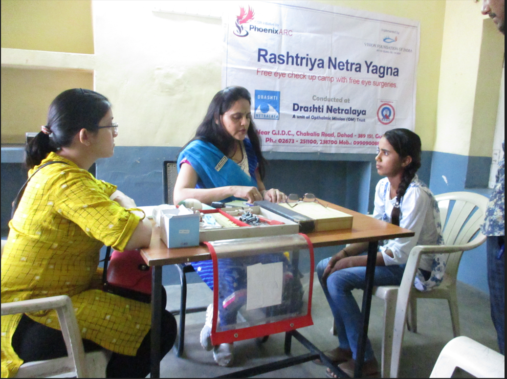 Patient receiving an eye assessment at a diagnostic camp