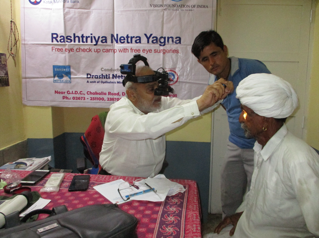 Eye specialist examining a patient during a diagnostic camp